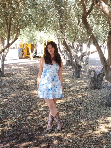 Kate, part of the Pinky Promised Childcare team, standing outdoors among trees